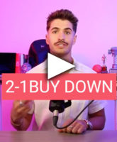 a man sitting at a table with a microphone in front of him.